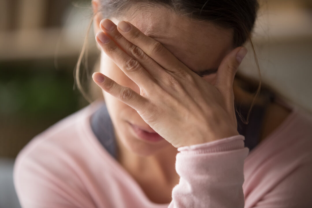 Woman experiencing chronic headache pain